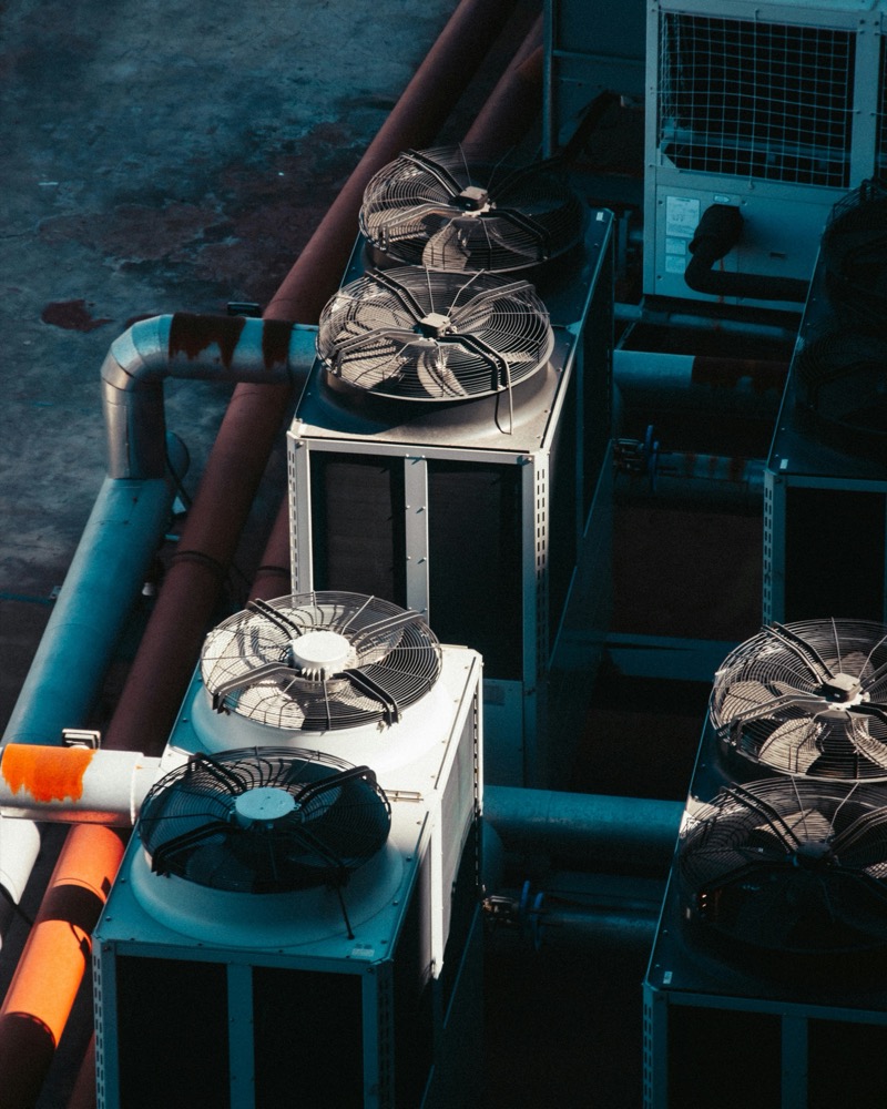 A rooftop array of commercial HVAC condenser units serviced by Atlanta Metro Airflow.